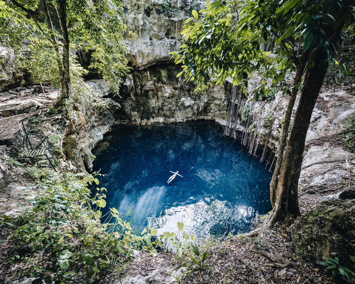 Aerial view of blue lagoon (cenote) in jungle