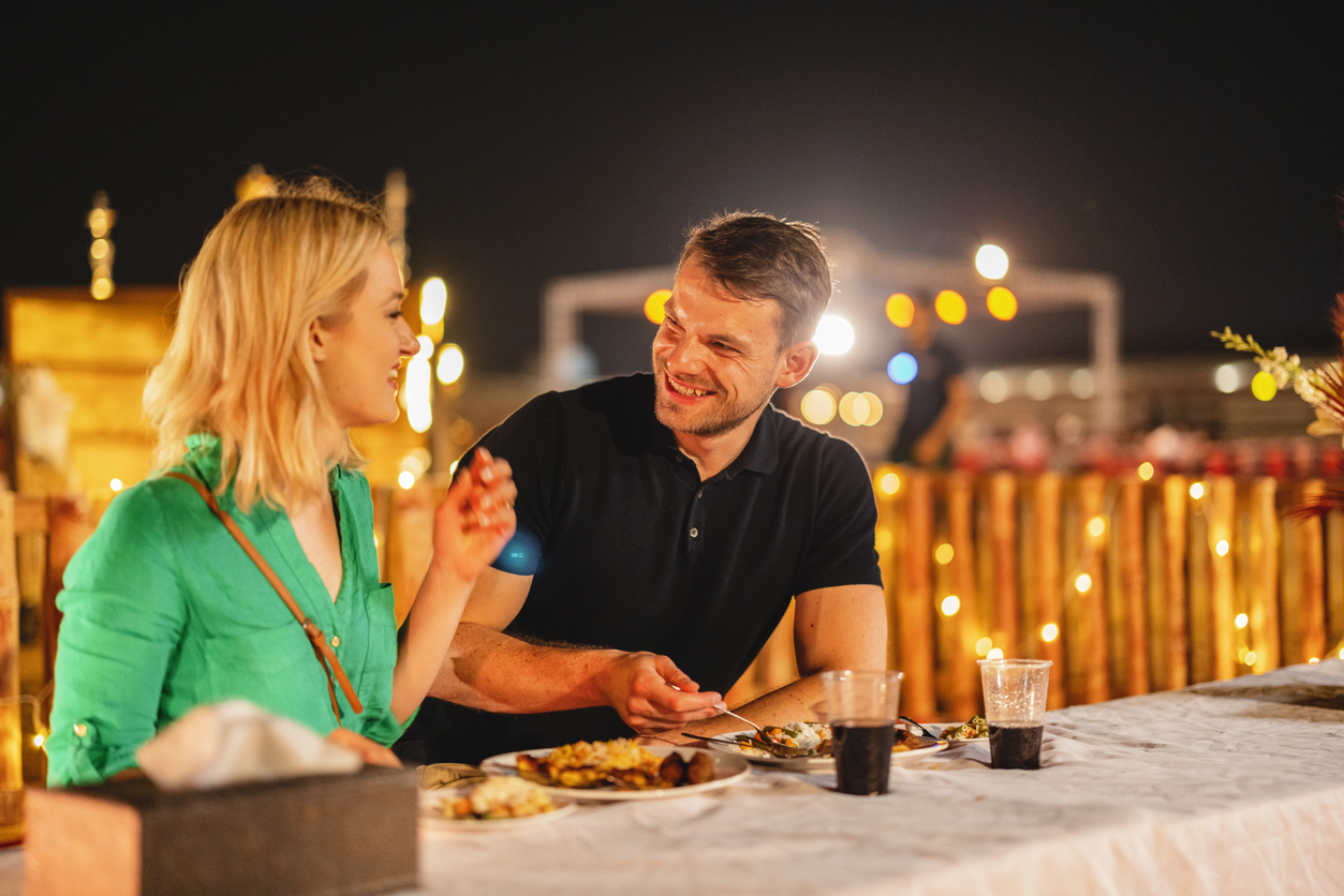 Young Adult Tourists Having Fun At Dinner In A Safari Camp in Dubai