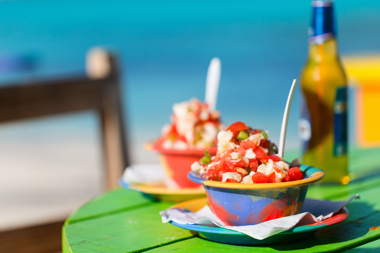 two Bahamian conch salads on a green table