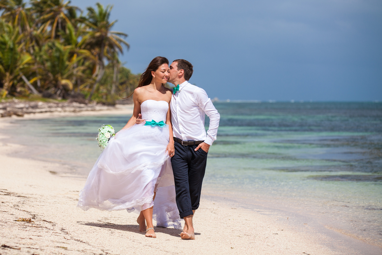 Beach couple walking on romantic travel honeymoon having fun.