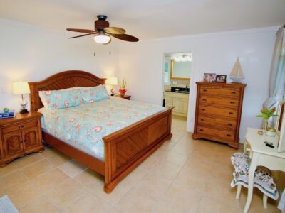 a queen sized bed inside a villa in Andros Beach Club