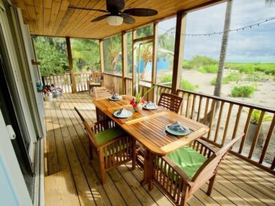 Dining area by the balcony in a villa in Andros Beach Club
