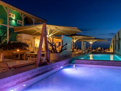 Pool inside BijBlauw Boutique Hotel at night, lit by night lights