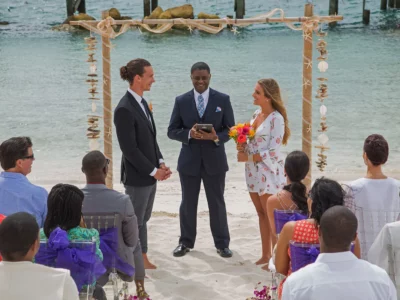 a wedding officiator, a couple getting married, and wedding guests inside Warwick Paradise Island
